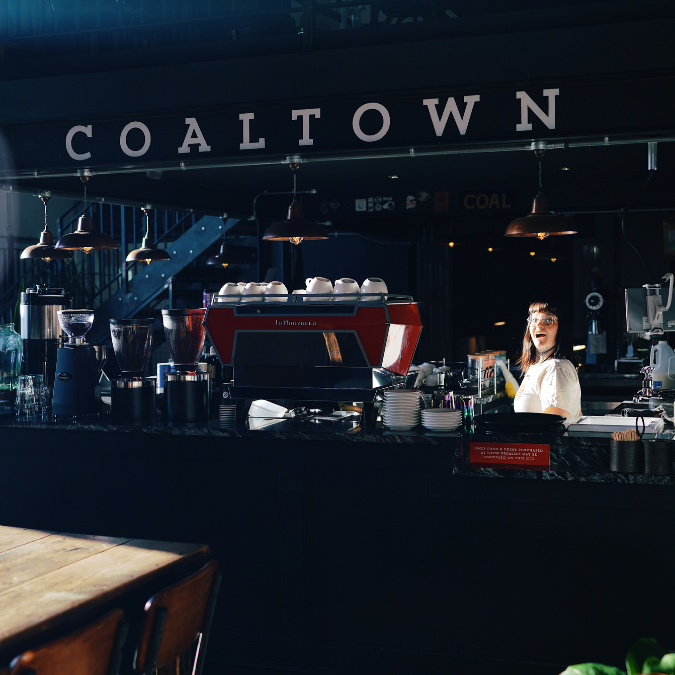 Coaltown employee smiling in the cafe