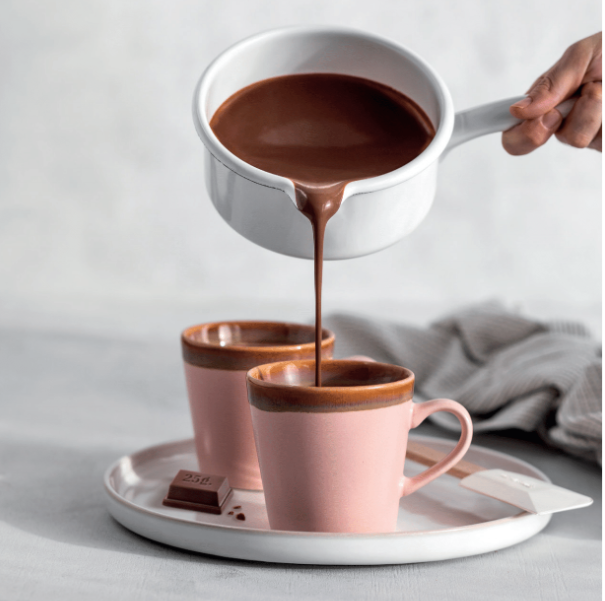 Simón Coll drinking chocolate bar, melted with milk, and being poured from a saucepan in to mugs