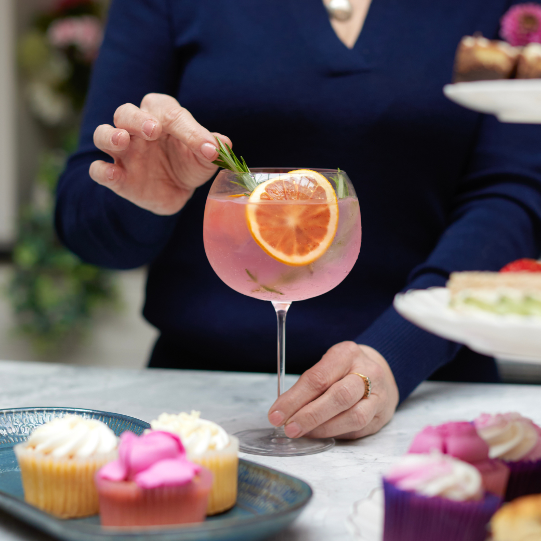 A photo of a mother with a glass of gin and tonic